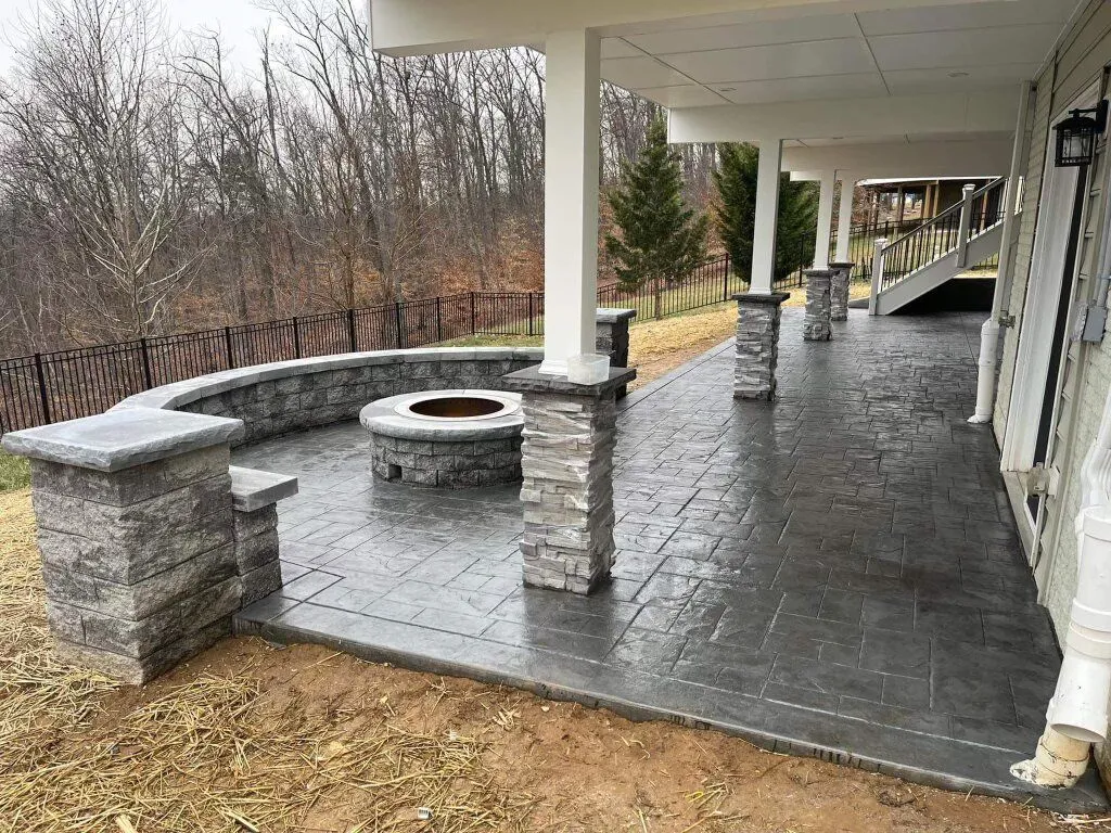 Custom concrete patio with an integrated fire pit by Brijo Concrete Solutions