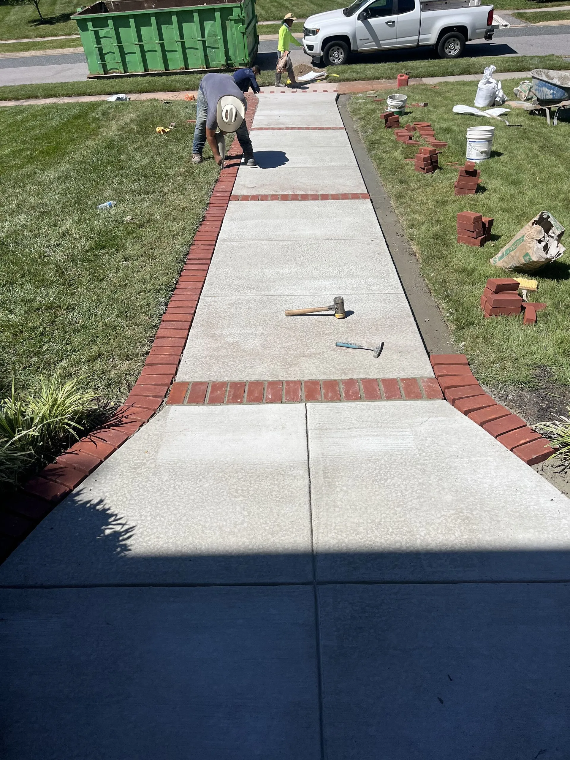 Clean concrete sidewalk installation with precise edging by Brijo Concrete Solutions in Glen Burnie MD