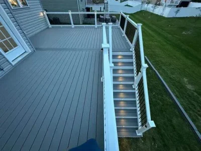 Ascending, lit steps to a patio for outdoor relaxation at night.